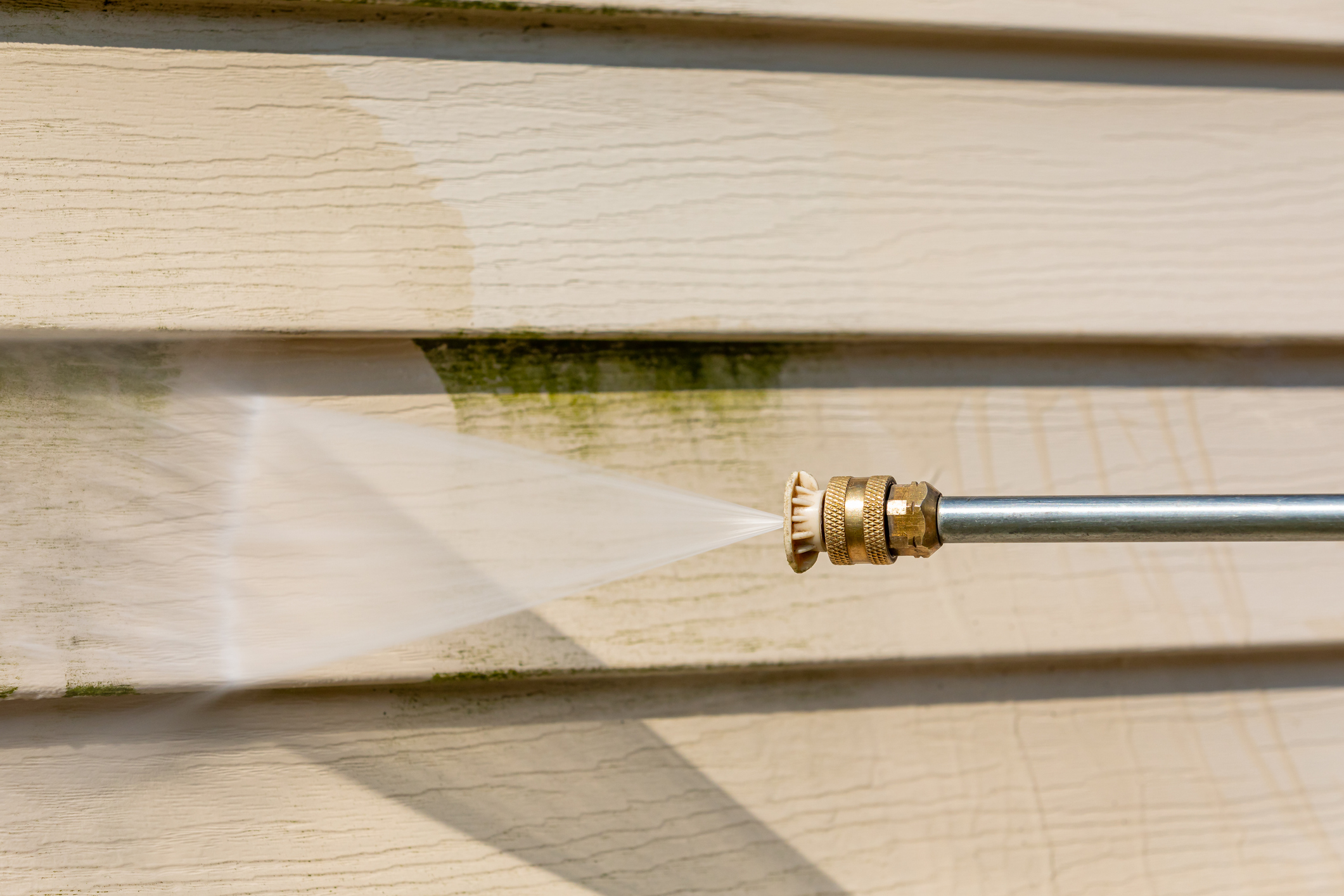 Cleaning algae, mold and mildew from vinyl siding of house with pressure washer. Home repair, maintenance and exterior cleaning concept. Cleaning algae, mold and mildew from vinyl siding of house with pressure washer. Home repair, maintenance and exterior cleaning concept.